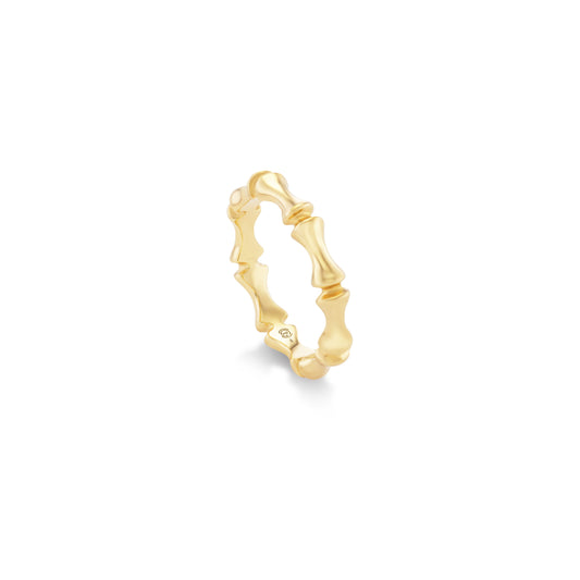Gold ring with a unique bamboo design on a white background