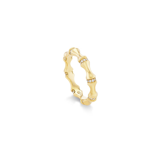 Gold ring with a bamboo design and diamonds on a white background