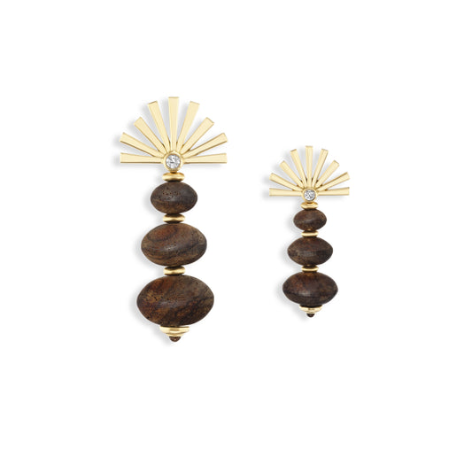 Pair of earrings with gold sunburst tops and wooden beads on a white background