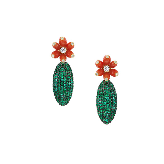 A pair of cactus-shaped earrings with emeralds and white diamonds, the earrings have a green and orange color scheme with a textured surface.
