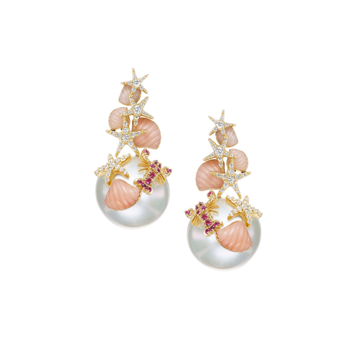 A pair of pearl drop earrings with yellow gold accents, featuring diamonds and rubies set in carved coral embellishments.