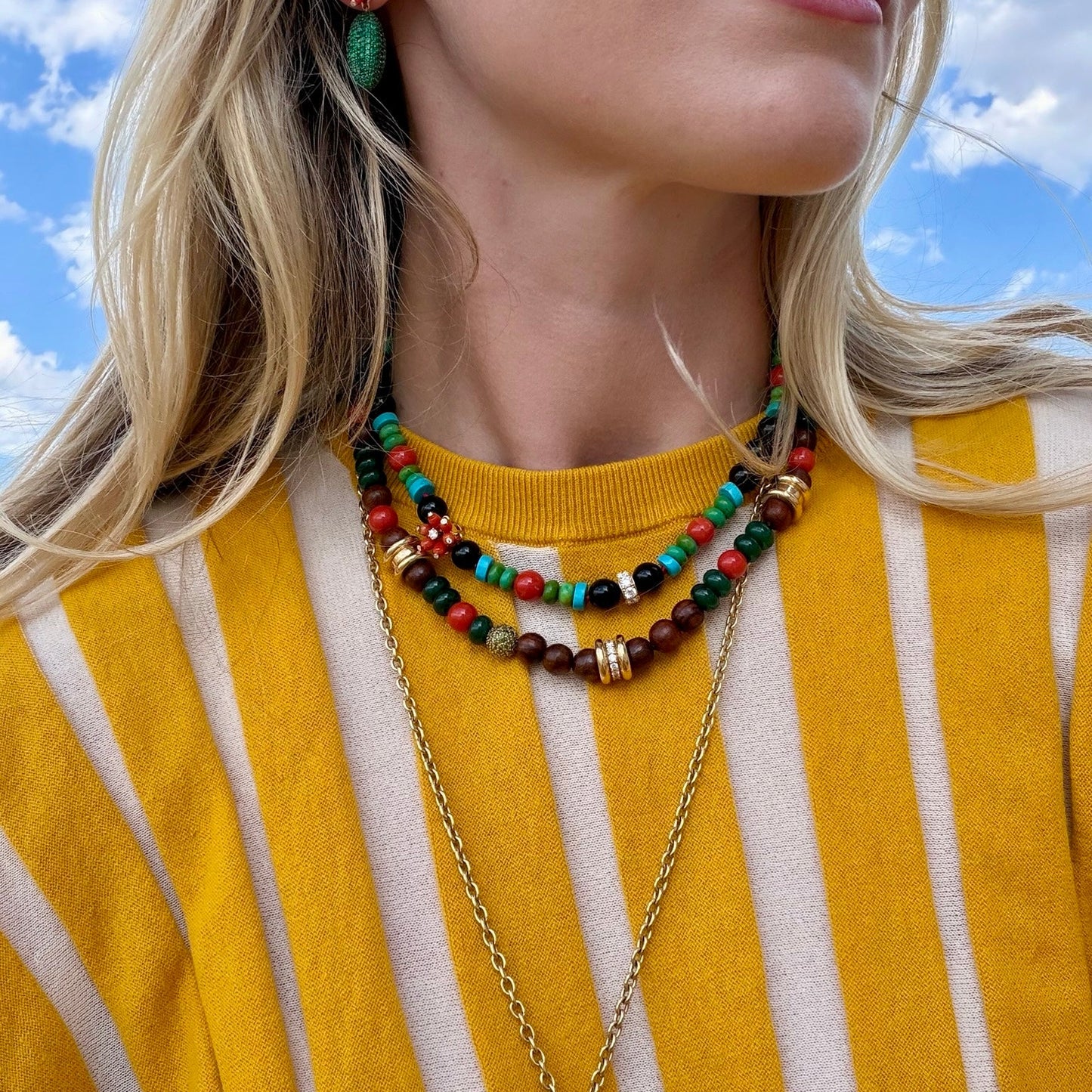 Woman wearing beaded necklaces.