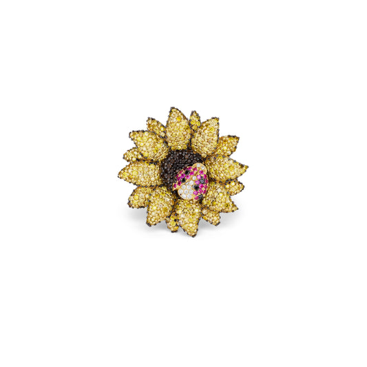Sunflower-shaped ring with gemstones on a white background