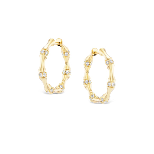 Gold hoop earrings with diamond accents on a white background