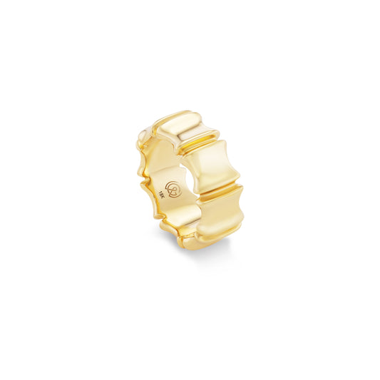 Gold ring with a bamboo design on a white background