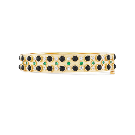 Gold bracelet with black, green, and clear gemstones on a white background