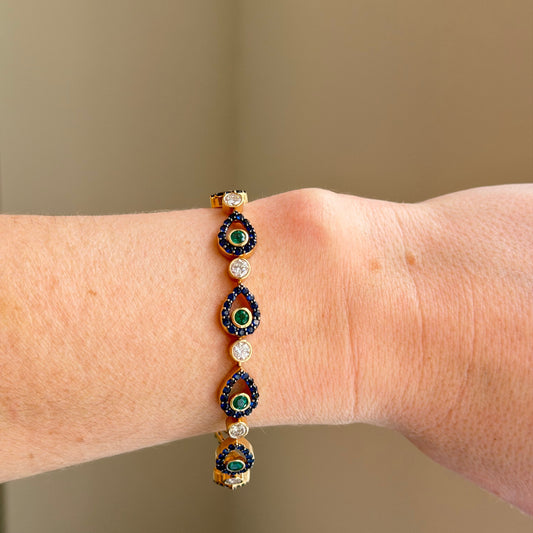 colored peacock inspired tennis bracelet on hand