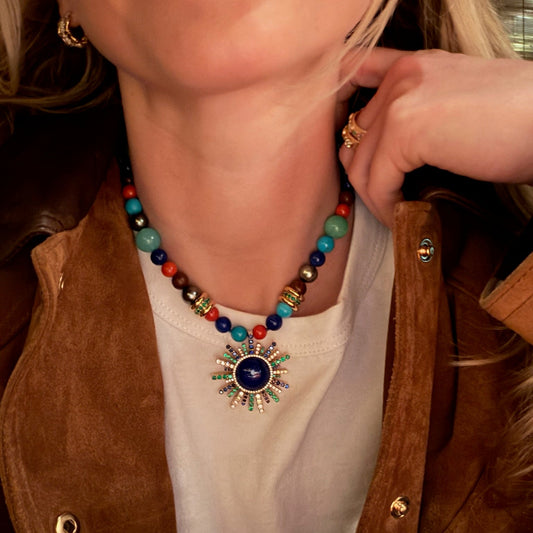 Woman wearing beaded necklace.