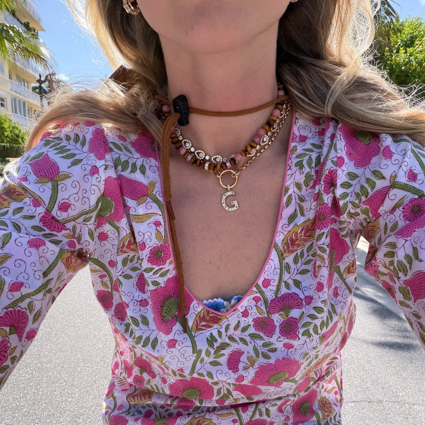 Woman wearing printed dress and necklaces