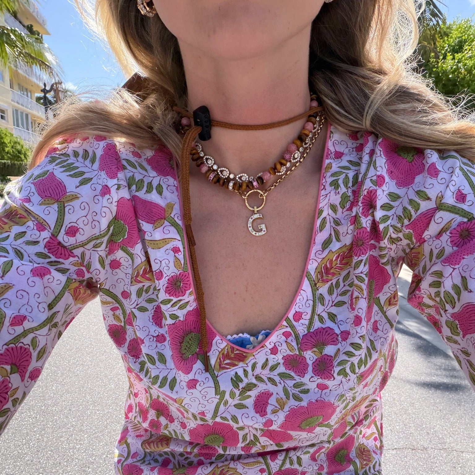 Woman wearing printed dress and necklaces