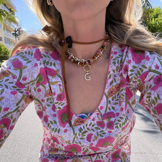 Woman wearing printed dress and necklaces