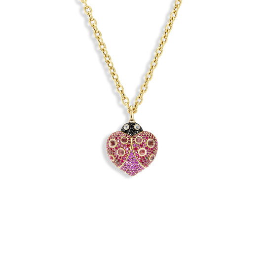 Heart-shaped pendant with pink stones on a gold chain against a white background