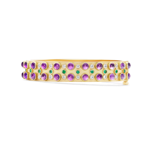 Gold ring with colorful gemstones on a white background