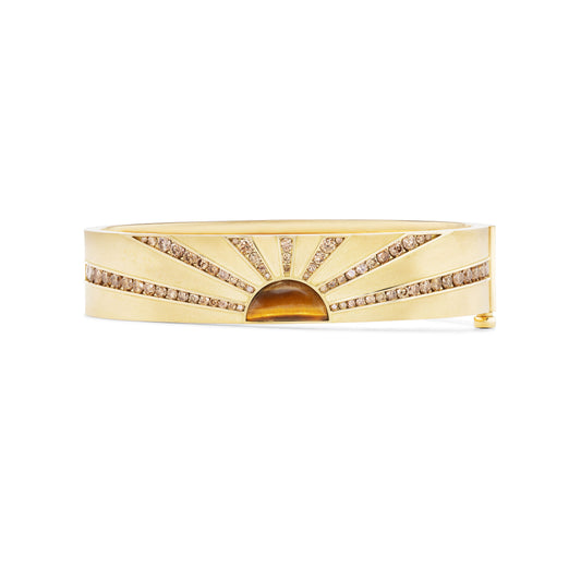 Gold bracelet with diamond accents on a white background
