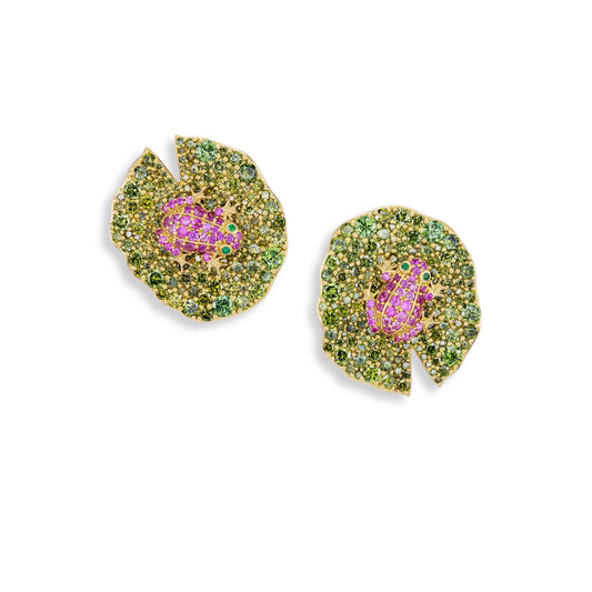 Pair of lily pad-shaped earrings with pink frogs and green accents on a white background