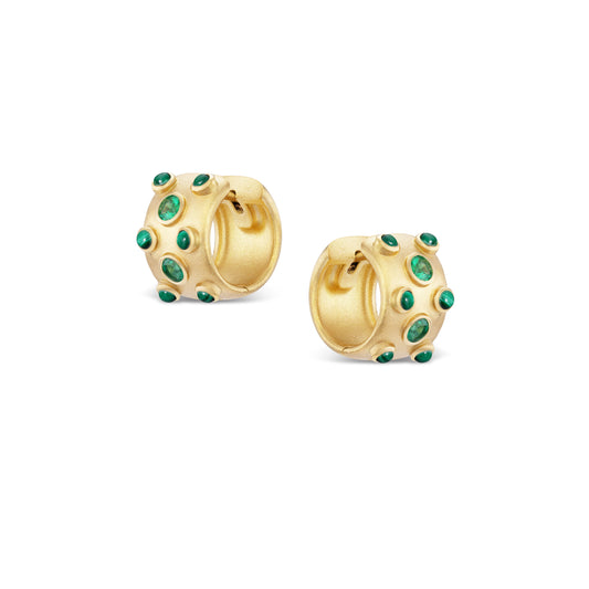 Gold hoop earrings with green gemstones on a white background