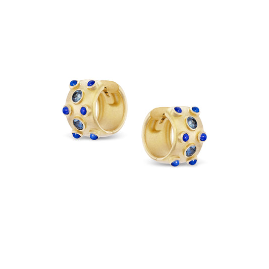 Gold hoop earrings with blue gemstones on a white background