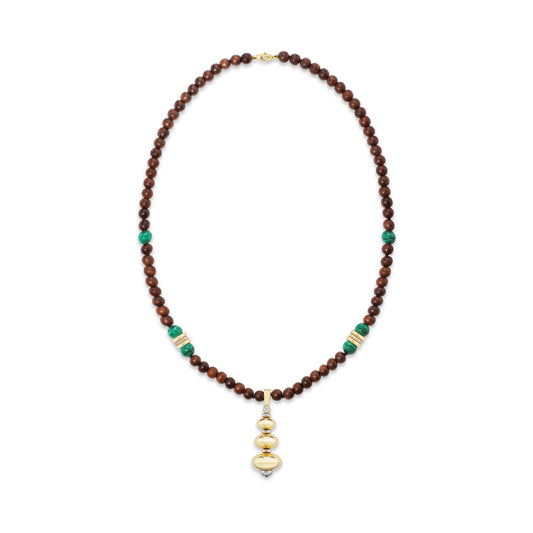 Beaded necklace on white background with gold pendant.