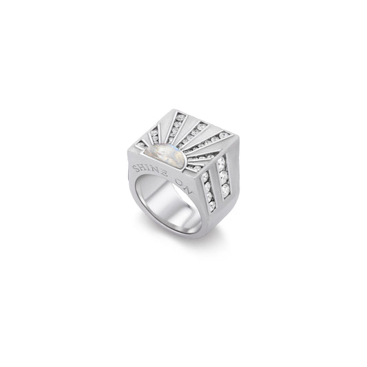 Silver ring with a central pearl and diamond accents on a white background