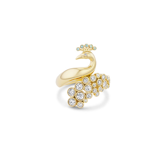 Gold peacock-shaped ring with crystal details on a white background