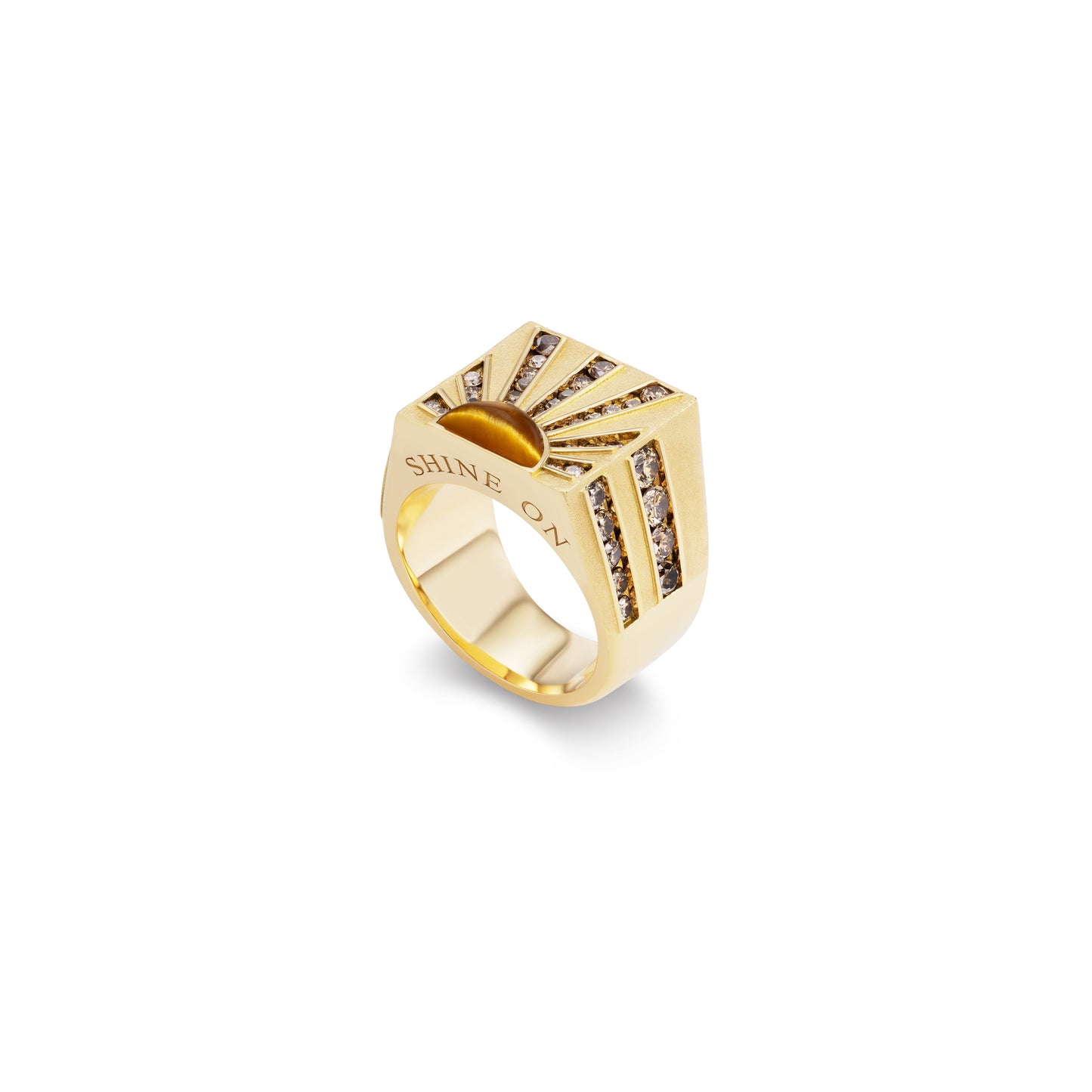 Gold ring with sunburst design and embedded stones on a white background