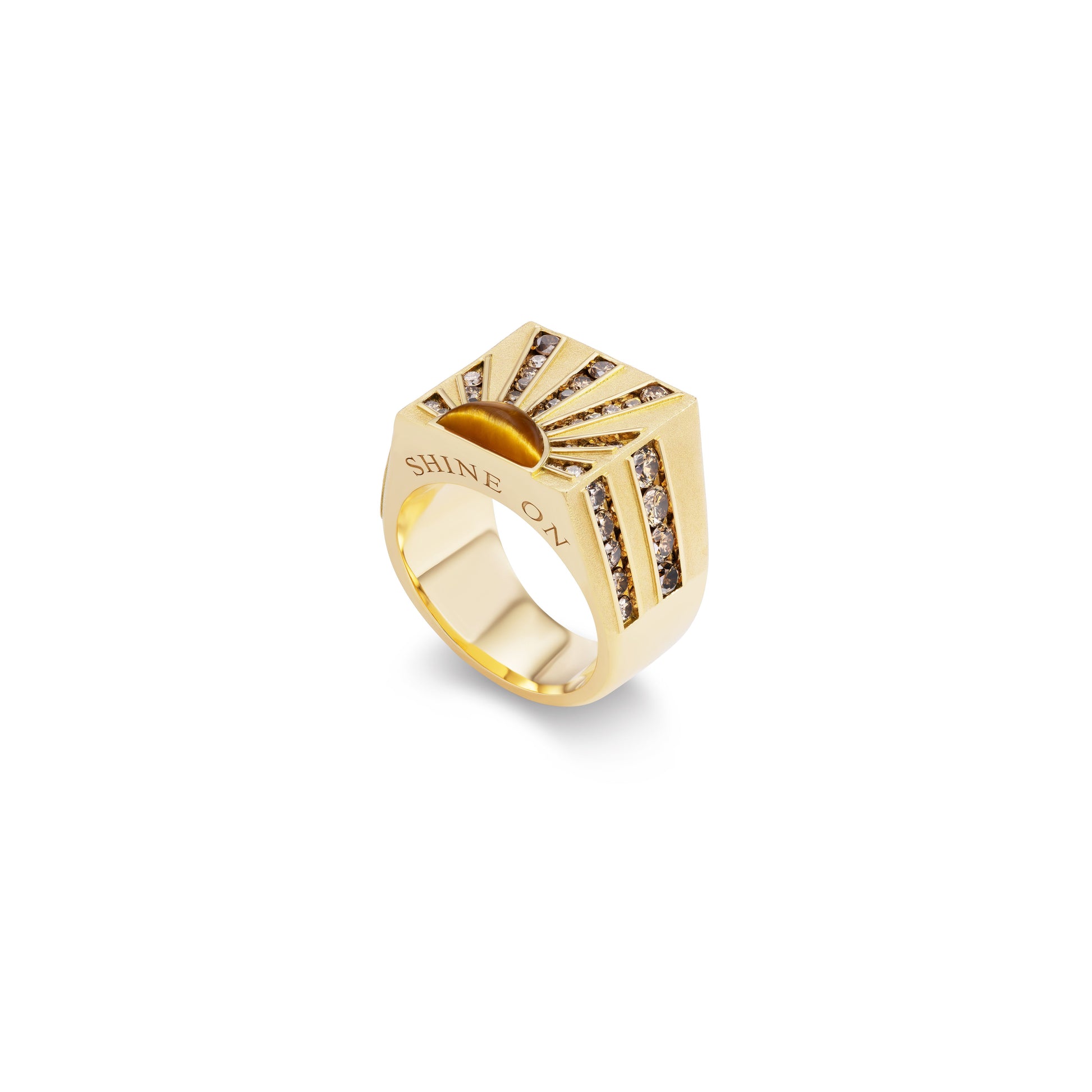 Gold ring with sunburst design and embedded stones on a white background