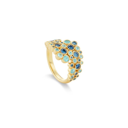 Gold ring with blue gemstones on a white background