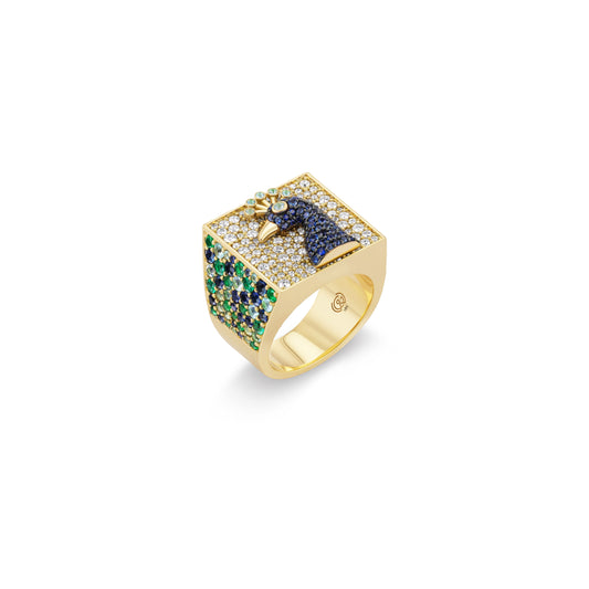 Gold ring with a peacock and gemstones on a white background