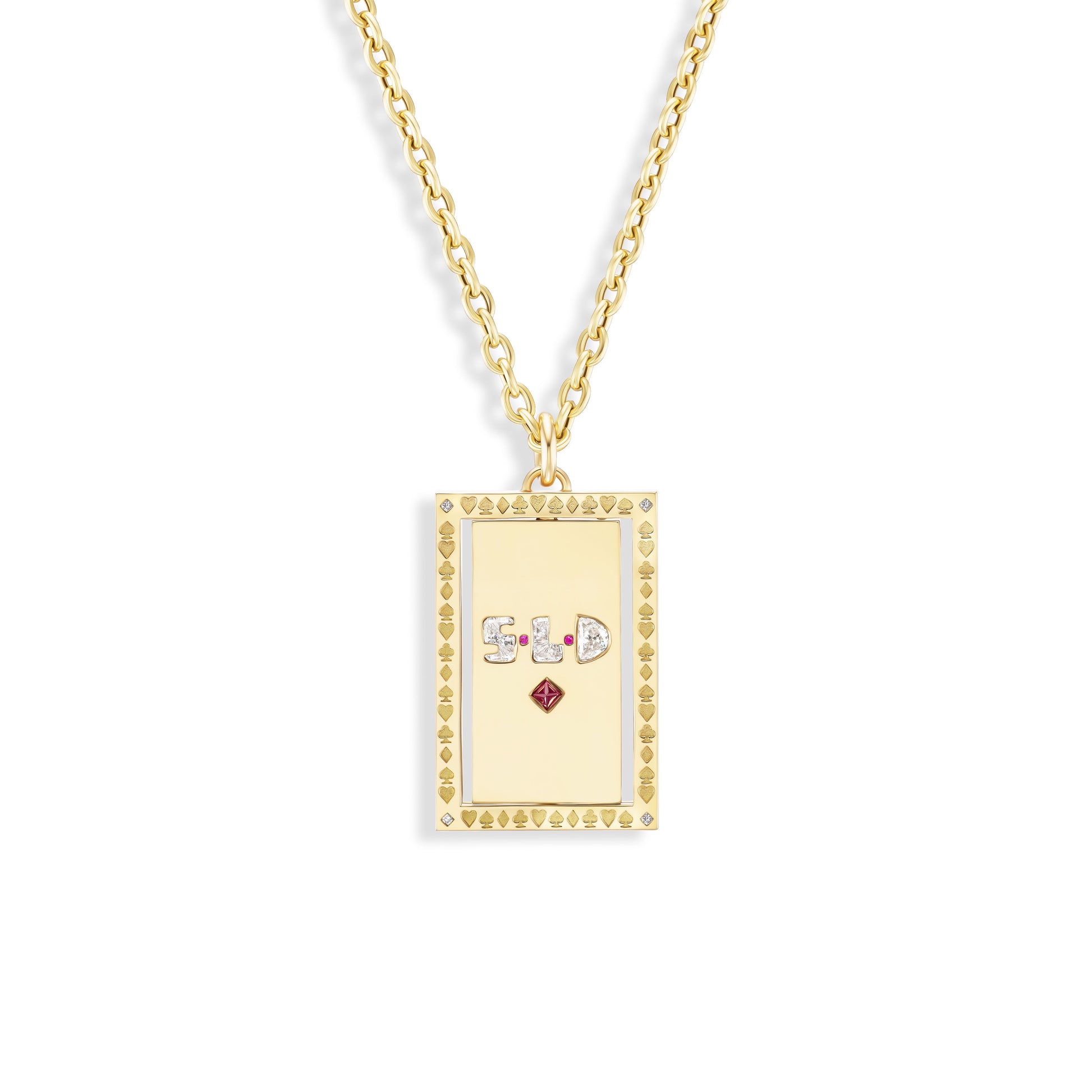Gold necklace with a rectangular pendant featuring symbols and a red gemstone on a white background